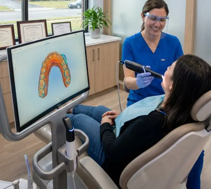 Cosmetic dentist in NJ showing a patient a 3D digital model of their teeth using AI and digital impressions technology.
